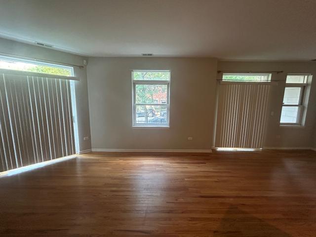 1461 South Halsted Street, Unit 1B Chicago, IL 60607 - Photo 20 of 20 an empty room with wooden floor and windows