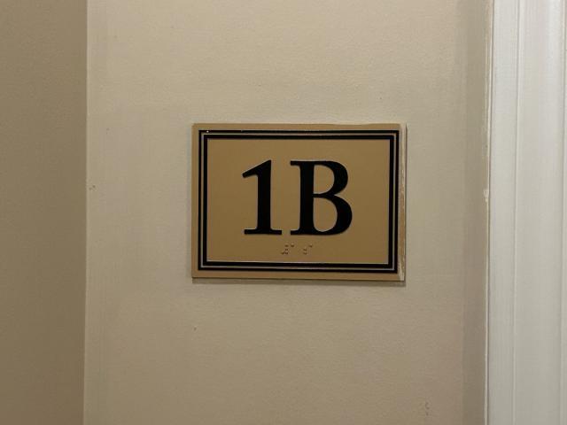 1461 South Halsted Street, Unit 1B Chicago, IL 60607 - Photo 5 of 20 a sign that is on a wooden wall