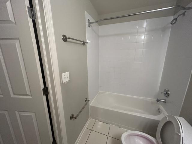 1461 South Halsted Street, Unit 1B Chicago, IL 60607 - Photo 8 of 20 a bathroom with a bathtub and a shower
