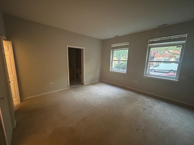 1461 South Halsted Street, Unit 1B Chicago, IL 60607 - Photo 9 of 20 a view of an empty room with windows