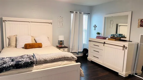 a bedroom with a bed and a dresser