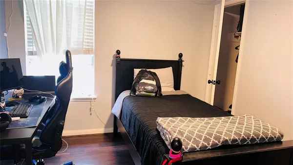 a bedroom with a bed and a window