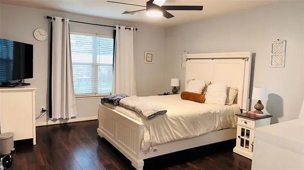 a bedroom with a bed and flat screen tv