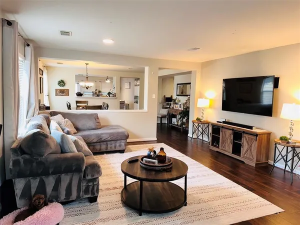 a living room with furniture and a flat screen tv