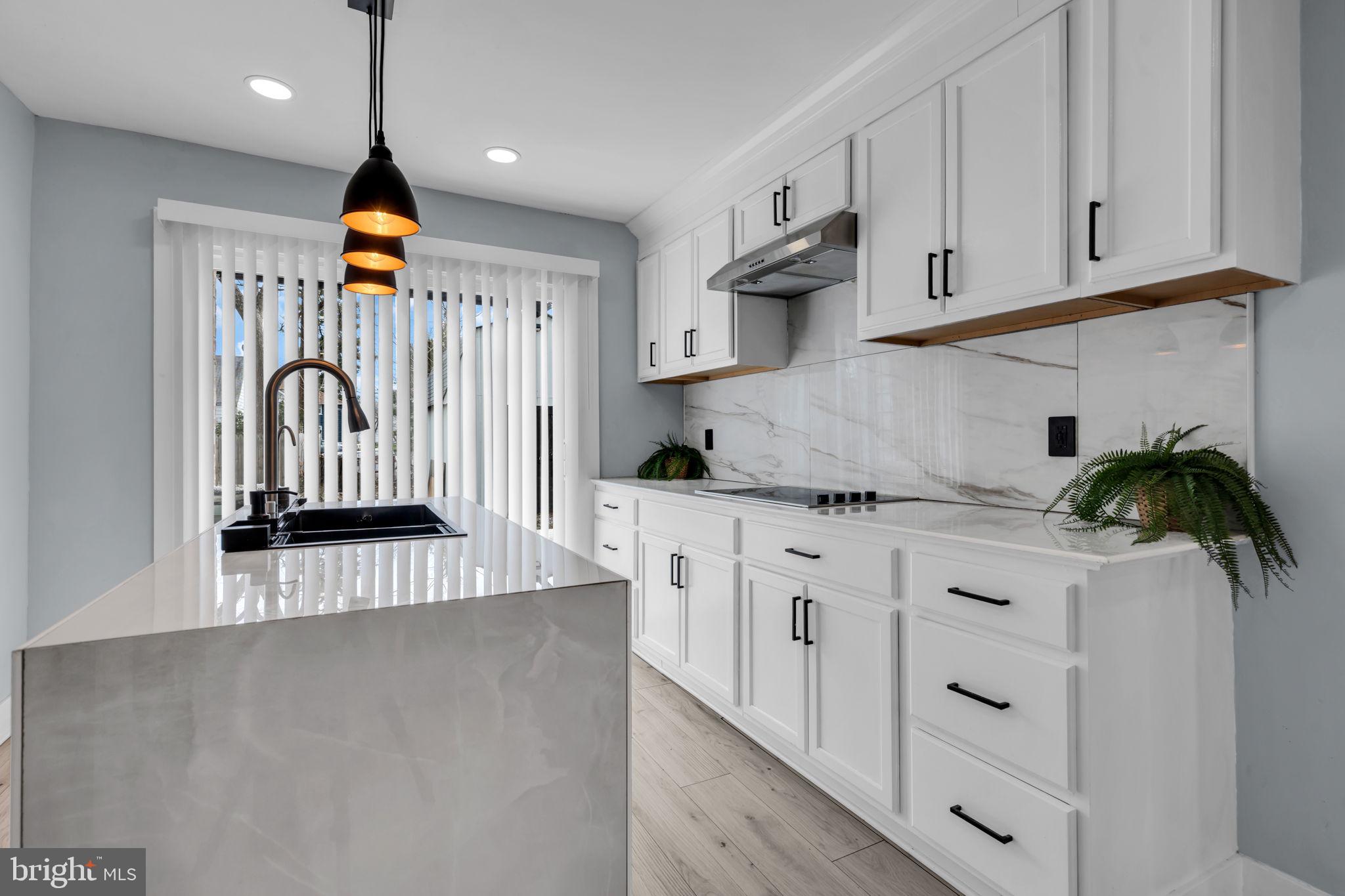 116 Hough Street Pemberton, NJ 08068 - Photo 12 of 25 a kitchen with white cabinets and window