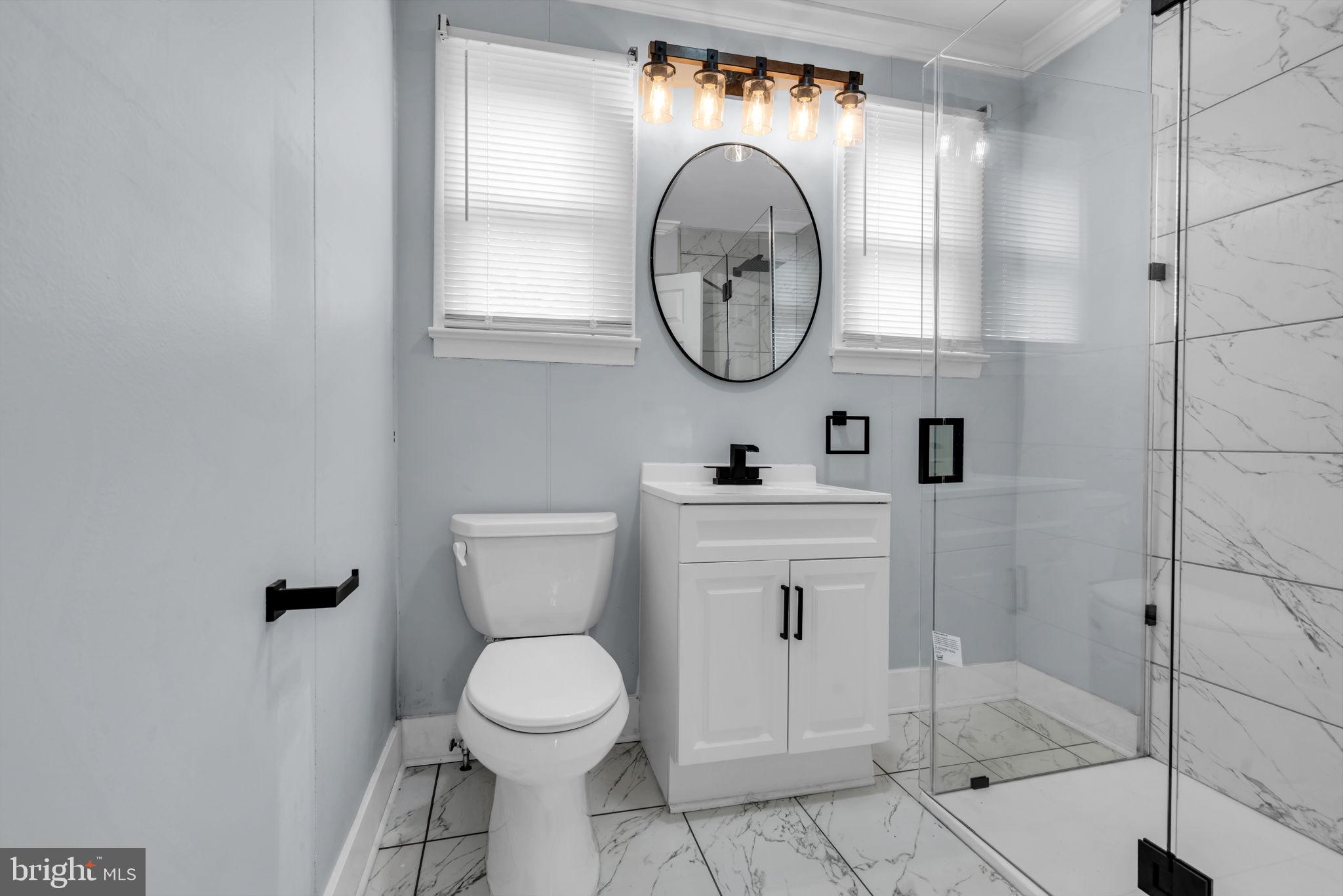 116 Hough Street Pemberton, NJ 08068 - Photo 17 of 25 a bathroom with a toilet sink and a mirror