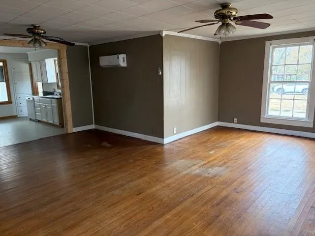 wooden floor in an empty room with a window