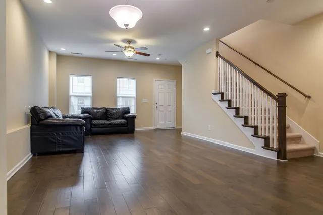 a living room with furniture and a chandelier
