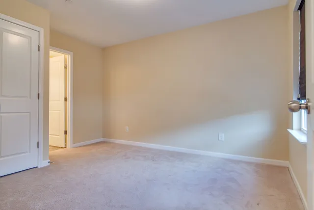 a view of an empty room and a window