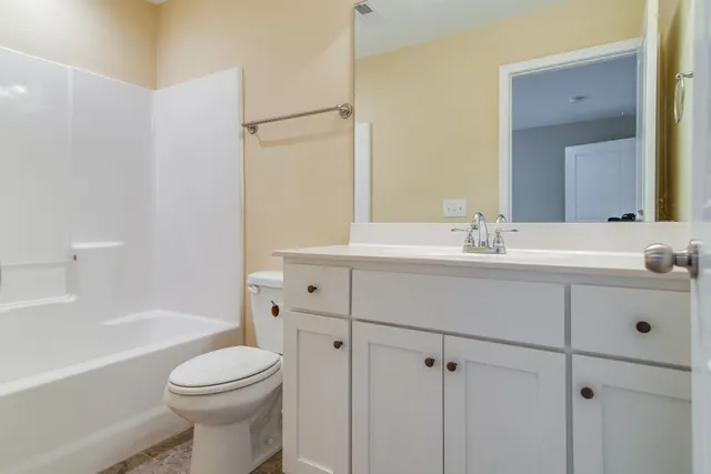 a bathroom with a sink mirror toilet and bathtub