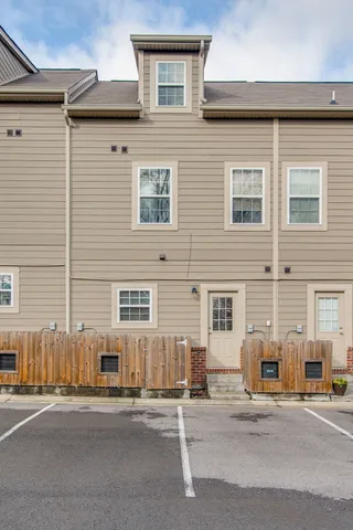 a front view of a house with a parking space