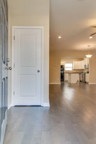 a view of a hallway with wooden floor