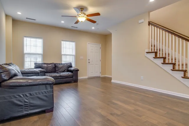 a living room with fireplace furniture and a wooden floor