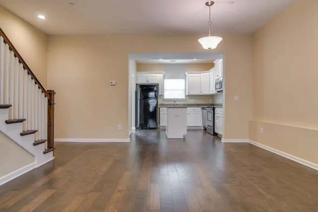 a view of empty room with wooden floor and fireplace