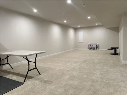 an empty room with a cabinet and mirrors