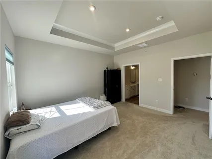 a bedroom with a bed and cabinet