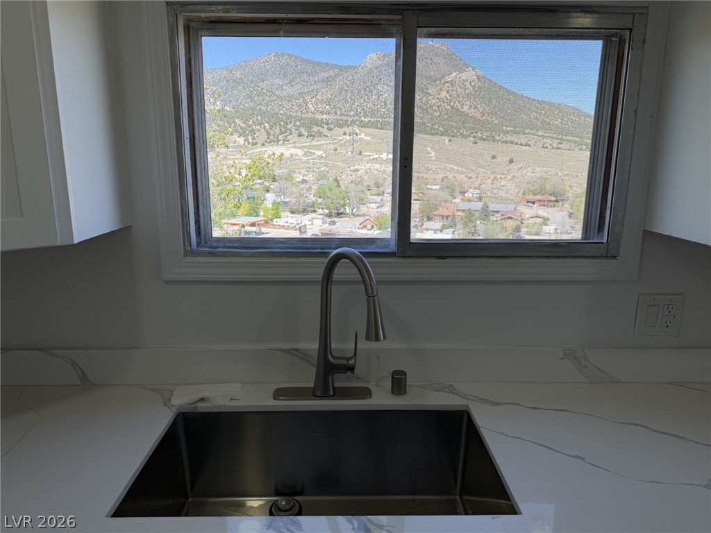 1 Carson Court Ely, NV 89301 - Photo 1 of 20 This kitchen offers a large sink with a window view of mountains and valleys.