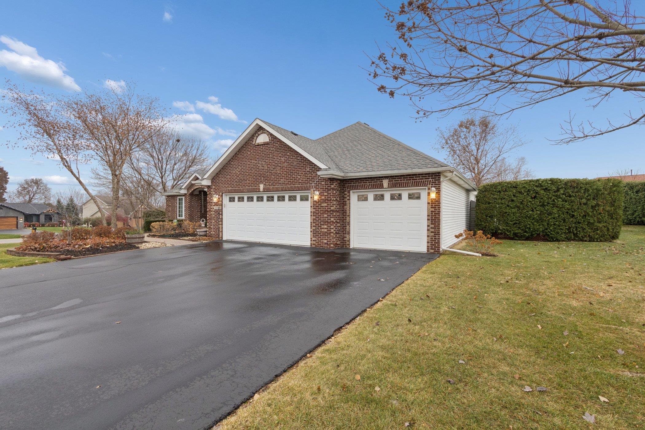 a front view of a house with a yard and garage