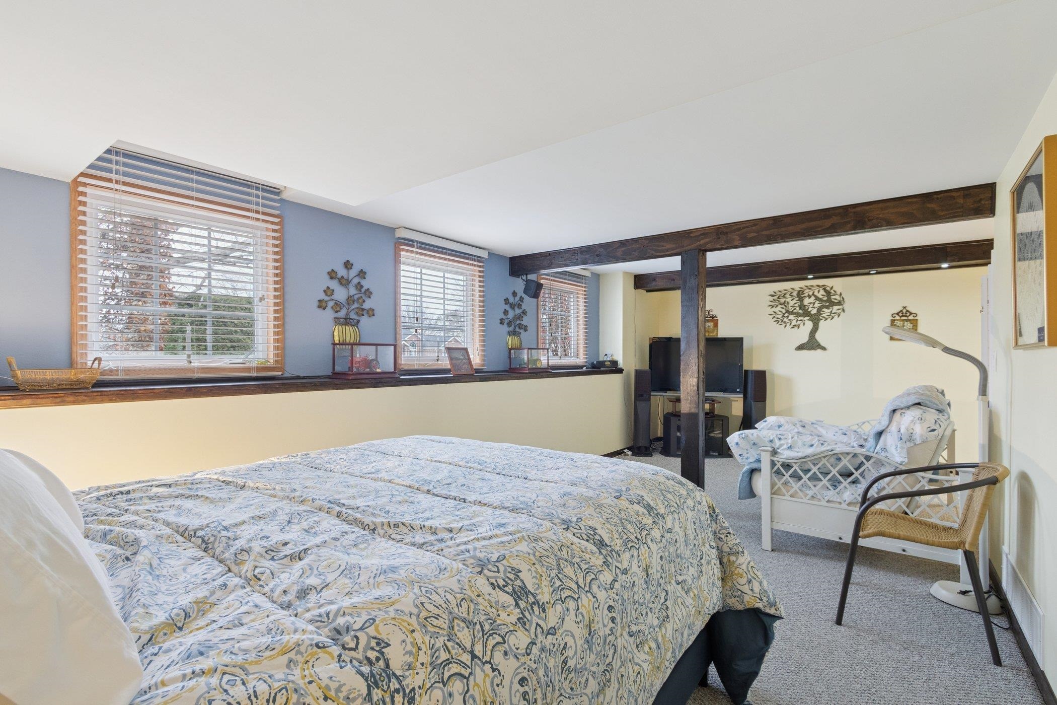 638 Merrion Road Roscoe, IL 61073 - Photo 30 of 64 a bed sitting in a bedroom next to a window with outer view