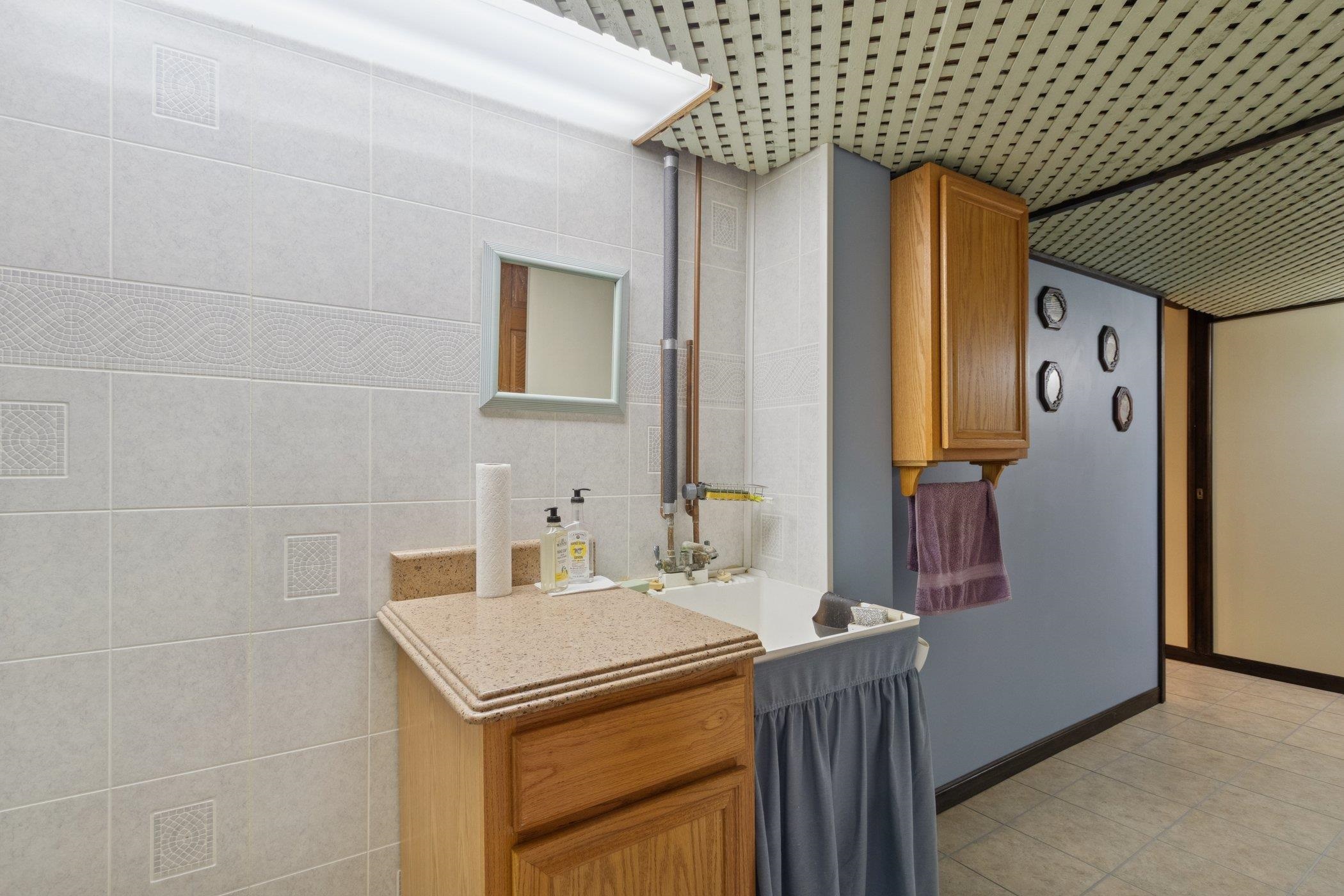 638 Merrion Road Roscoe, IL 61073 - Photo 33 of 64 a bathroom with a sink and mirror