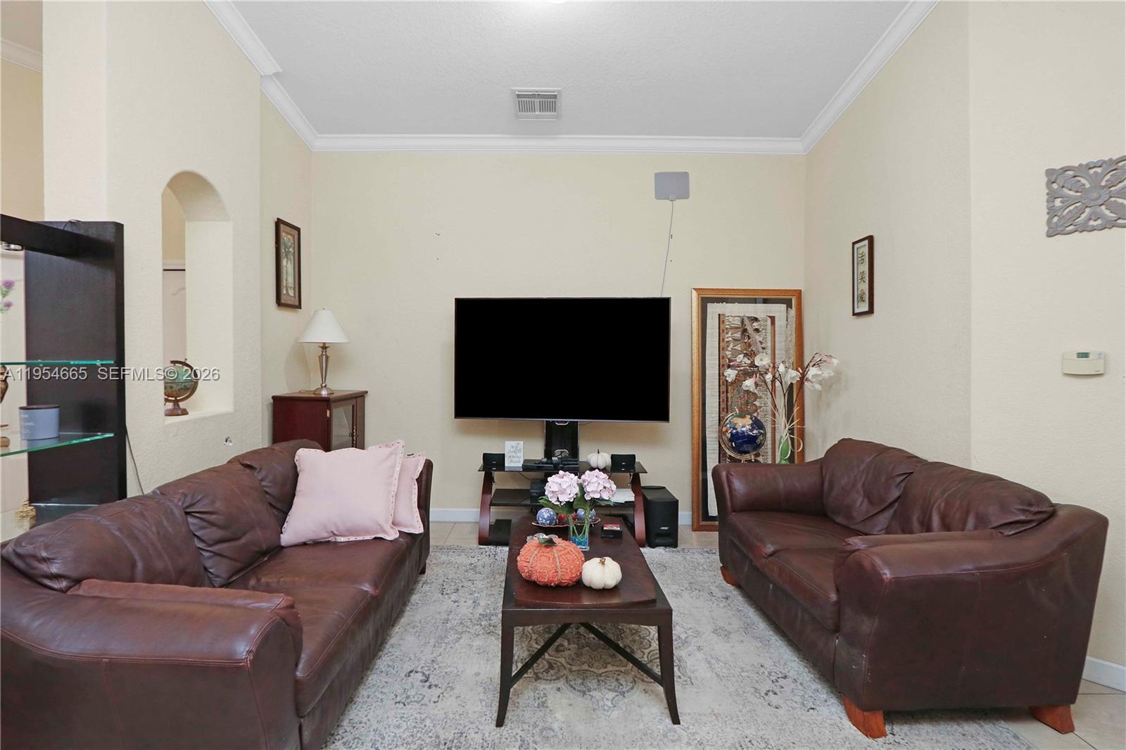 15382 Southwest 16th Terrace Miami, FL 33185 - Photo 3 of 26 a living room with furniture and a flat screen tv