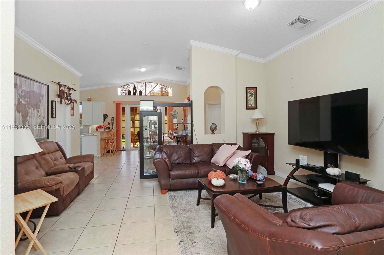 15382 Southwest 16th Terrace Miami, FL 33185 - Photo 4 of 26 a living room with furniture and a flat screen tv