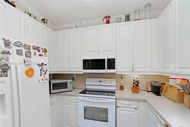 a kitchen with stainless steel appliances a stove a microwave and a refrigerator