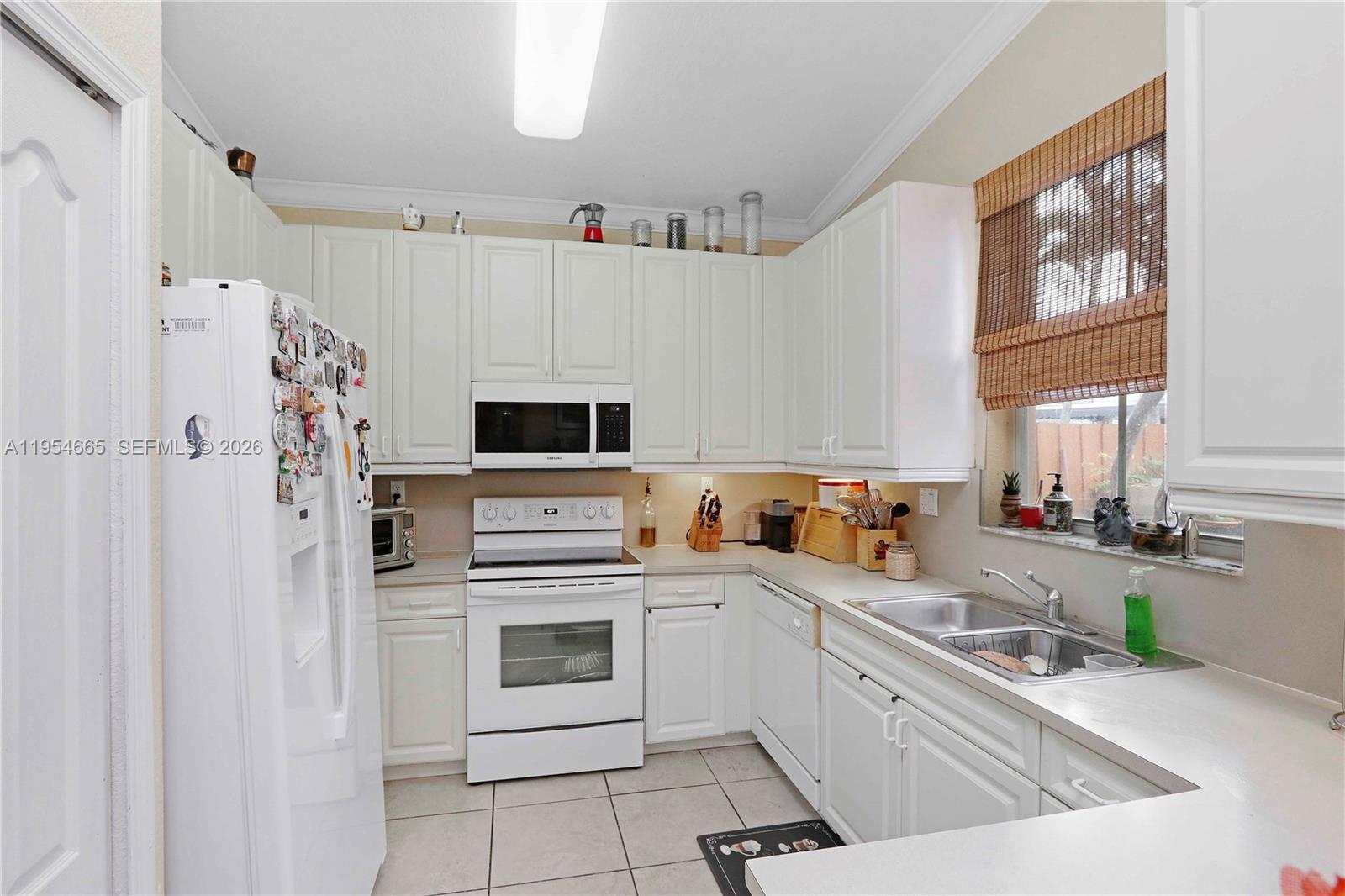 15382 Southwest 16th Terrace Miami, FL 33185 - Photo 8 of 26 a kitchen with stainless steel appliances a refrigerator sink and cabinets