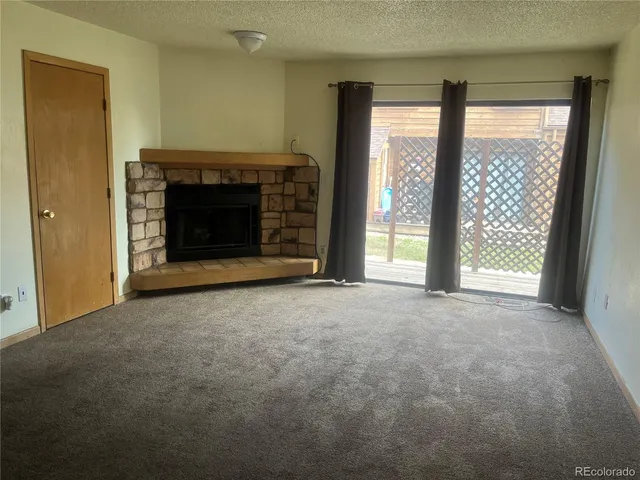 a view of an empty room with a fireplace
