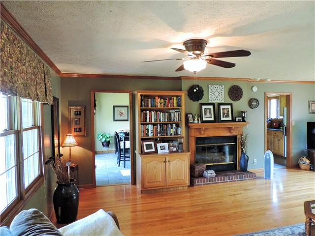 2920 Sweethome Road Chapmansboro, TN 37035 - Photo 4 of 20 After entering the solid wood front door, your living room has two ceiling fans, gas fireplace, built-in bookcase, and hardwood floors. Windows overlook front and back yard.