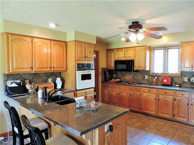 2920 Sweethome Road Chapmansboro, TN 37035 - Photo 7 of 20 Dream kitchen with solid surface countertops (and lots of them) and solid wood cabinets. New dishwasher and newer microwave. Refrigerator stays.