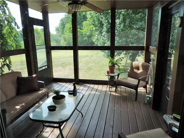 2920 Sweethome Road Chapmansboro, TN 37035 - Photo 9 of 20 Screened in back deck with ceiling fan, access doors to open deck and back yard.