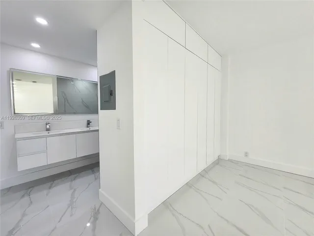 a spacious bathroom with a shower and a sink