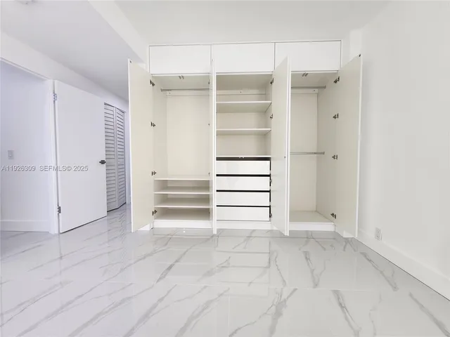 a bathroom with a double vanity sink toilet and a mirror