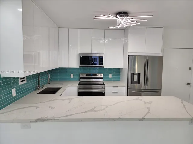 a kitchen with stainless steel appliances a refrigerator sink and cabinets
