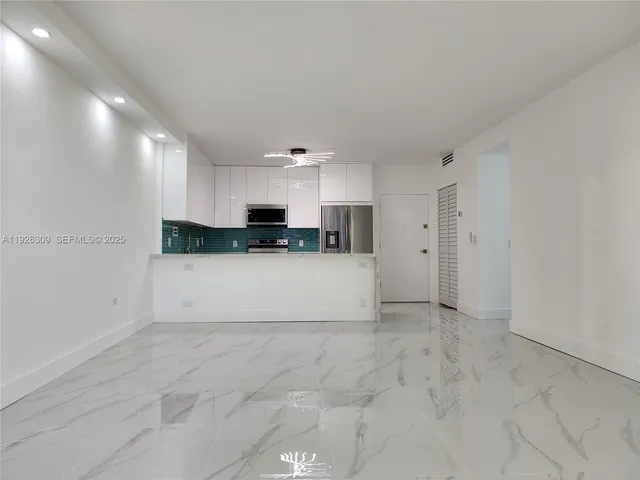a view of hallway with stairs and a bathroom