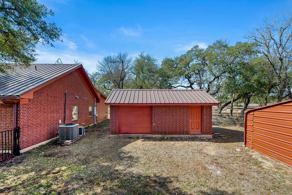 2795 Highway 290 Dripping Springs, TX 78620 - Photo 29 of 40 a front view of a house with a yard