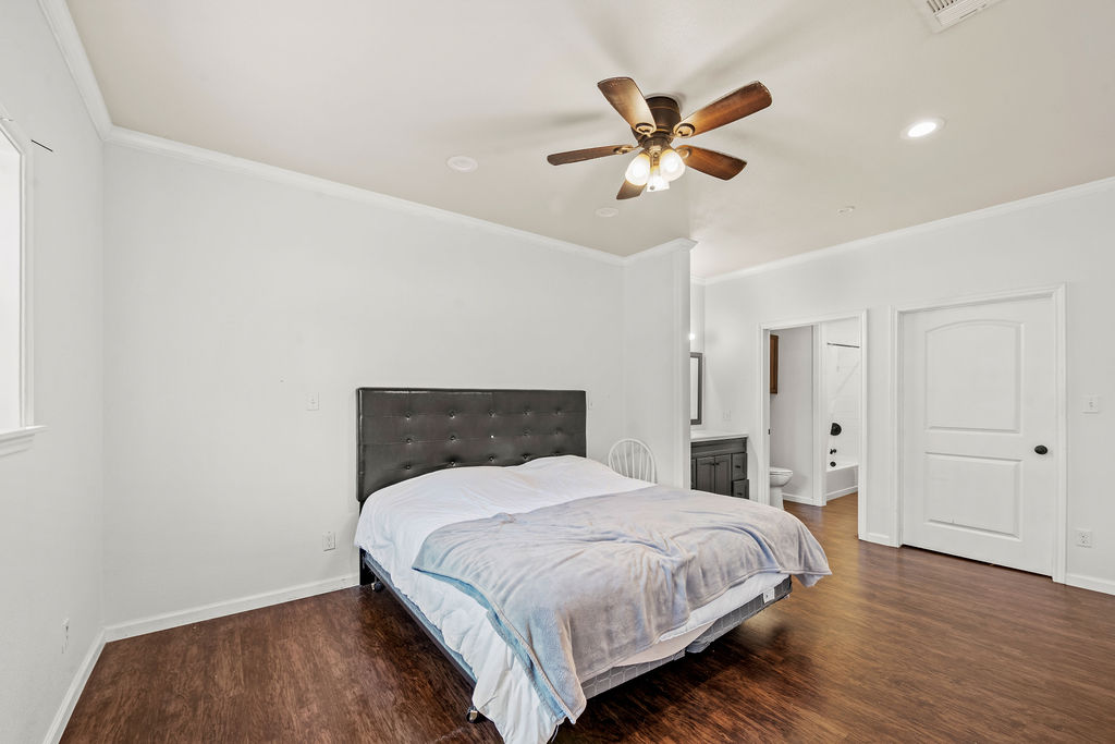 2795 Highway 290 Dripping Springs, TX 78620 - Photo 35 of 40 a bedroom with a bed and a ceiling fan