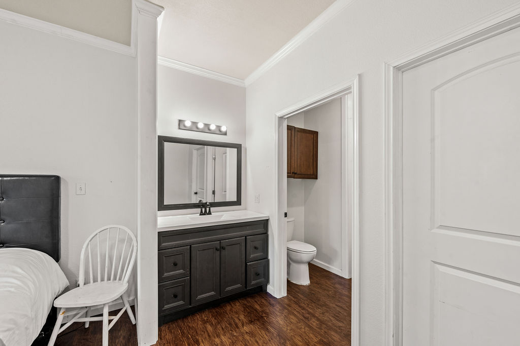 2795 Highway 290 Dripping Springs, TX 78620 - Photo 36 of 40 a bathroom with a toilet sink a mirror and vanity