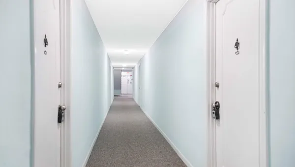 a view of a hallway with a wooden floor