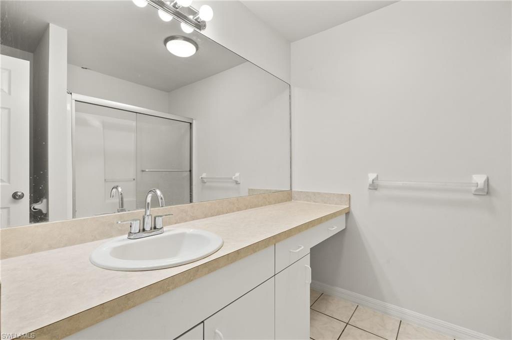 18396 Heather Road Fort Myers, FL 33967 - Photo 14 of 26 a bathroom with a sink and a mirror