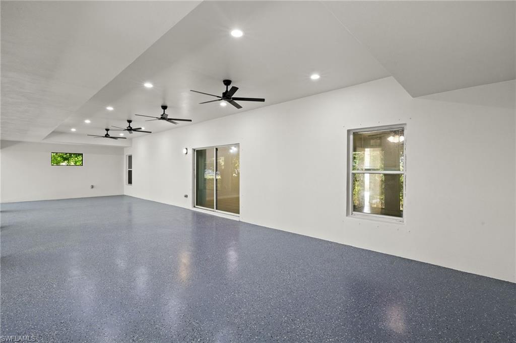 18396 Heather Road Fort Myers, FL 33967 - Photo 20 of 26 an empty room with windows and fireplace