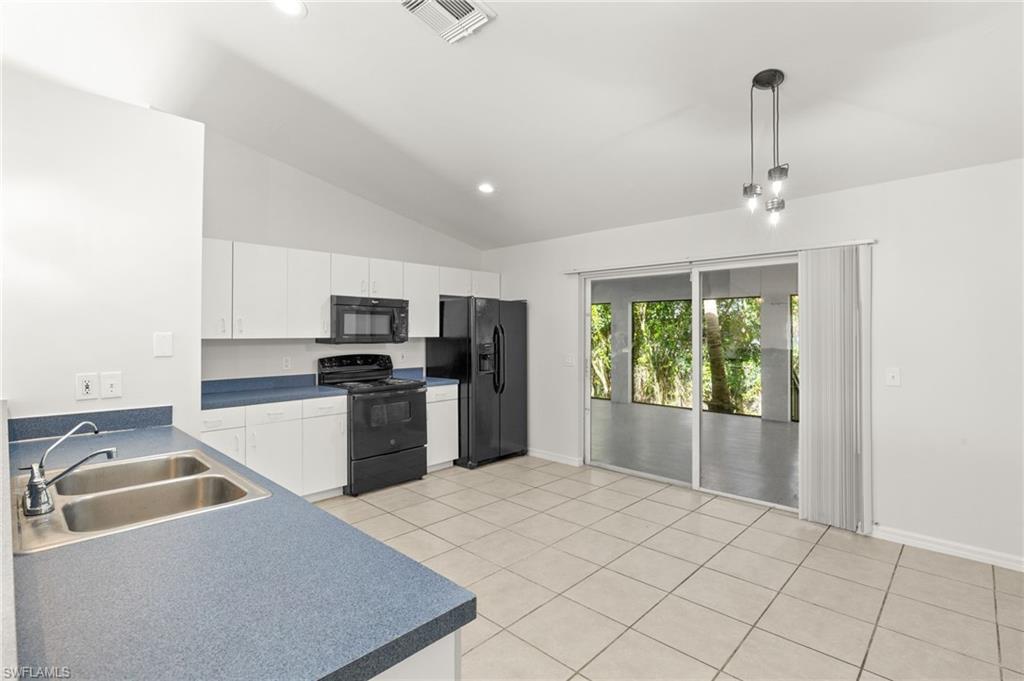 18396 Heather Road Fort Myers, FL 33967 - Photo 6 of 26 a kitchen that has a sink cabinets appliances and a window