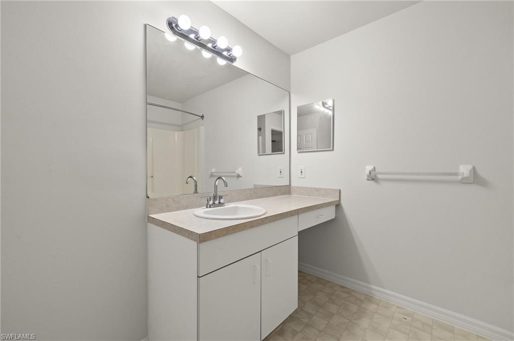 18396 Heather Road Fort Myers, FL 33967 - Photo 10 of 26 a bathroom with a sink and a mirror