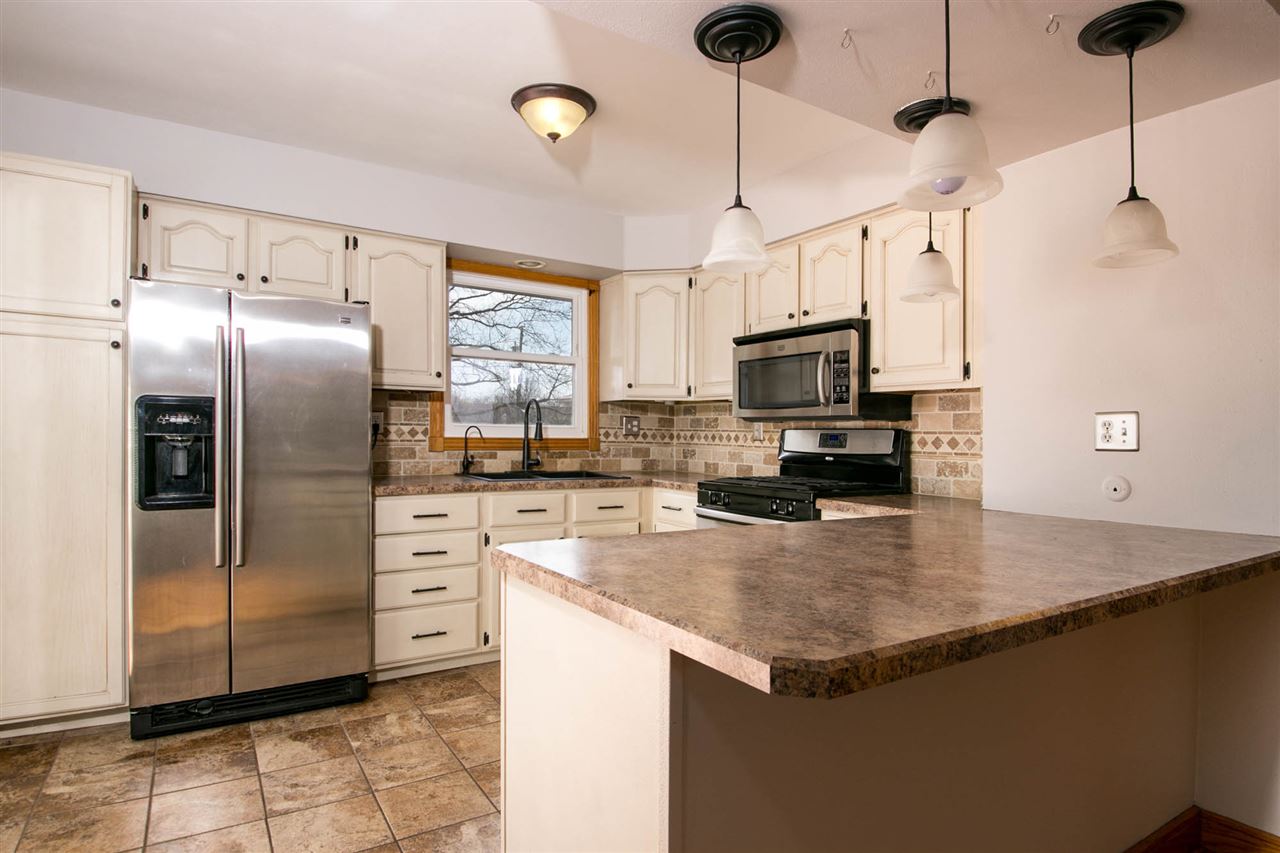 2893 Karr Road Belvidere, IL 61008 - Photo 6 of 25 a kitchen with stainless steel appliances granite countertop a refrigerator a stove a sink a oven with a island and chairs