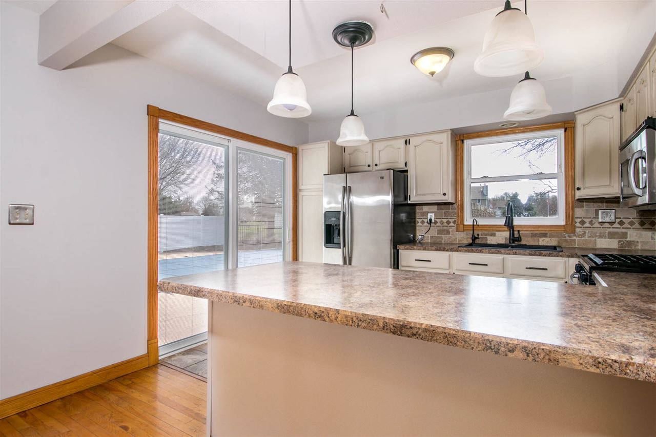 2893 Karr Road Belvidere, IL 61008 - Photo 7 of 25 a kitchen with stainless steel appliances granite countertop a refrigerator a sink and a stove