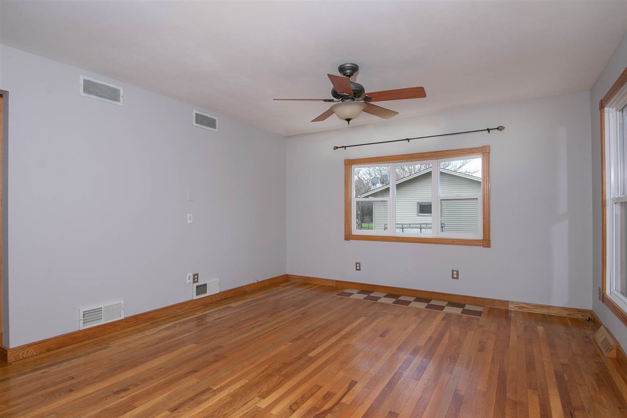 2893 Karr Road Belvidere, IL 61008 - Photo 9 of 25 a view of empty room with wooden floor and fan