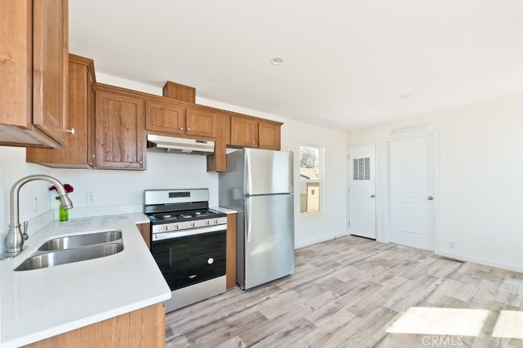 15252 Seneca Road, Unit 13 Victorville, CA 92394 - Photo 5 of 9 a kitchen with a sink a stove and refrigerator