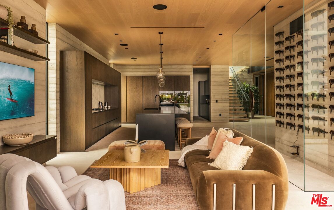 6889 Dume Drive Malibu, CA 90265 - Photo 11 of 41 a living room with furniture and a chandelier