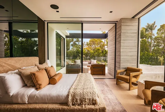 a bedroom with a large bed and a large window